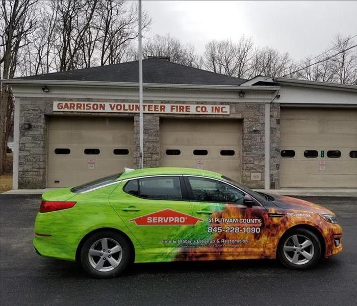 small SERVPRO sales car in front of volunteer fire department