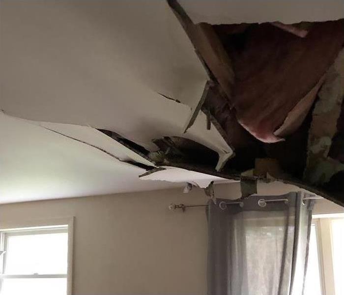 The ceiling in this home is caving in due to high winds that blew through 