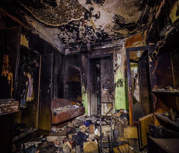 home with burned furniture and walls covered in soot