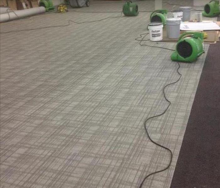 Commercial carpeted property; water damage; SERVPRO equipment drying area