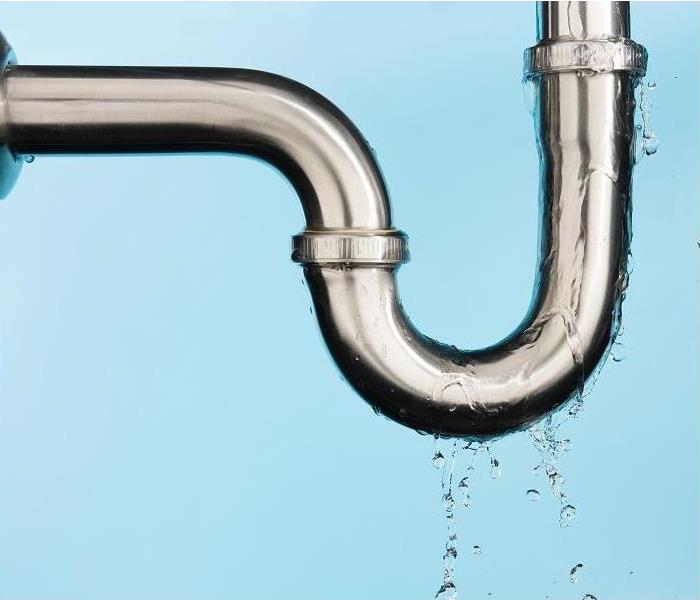 leaking under sink drainpipe; blue background