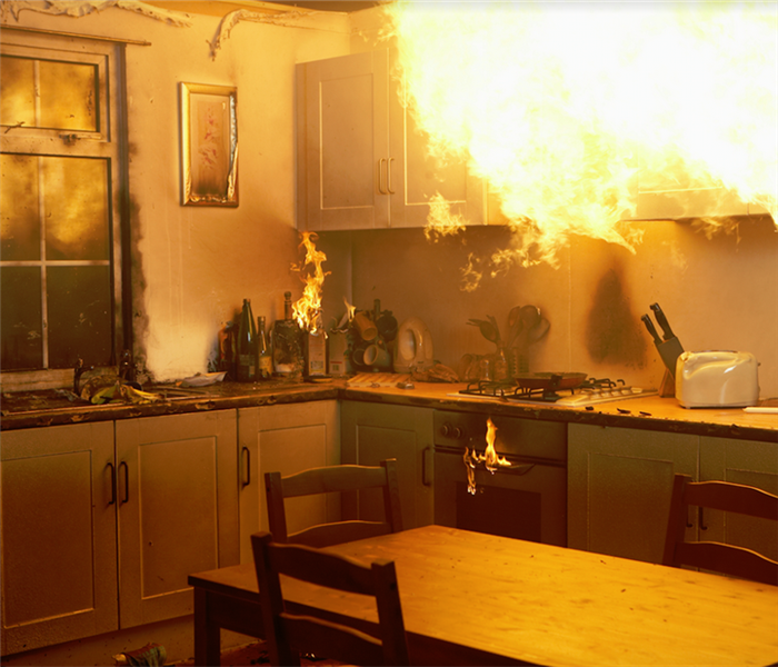 a kitchen with a fire raging by the stove