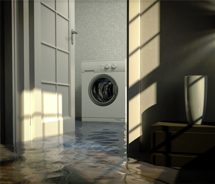 a flooded laundry room with water covering the floor