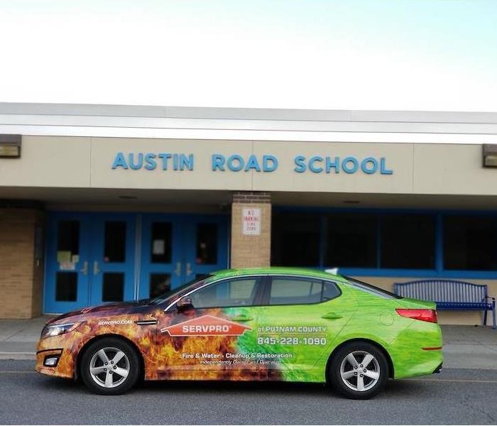 SERVPRO car parked in front of school